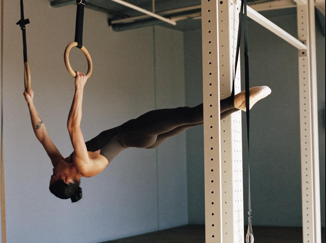 Athlete performing a core exercise on gymnastic rings
