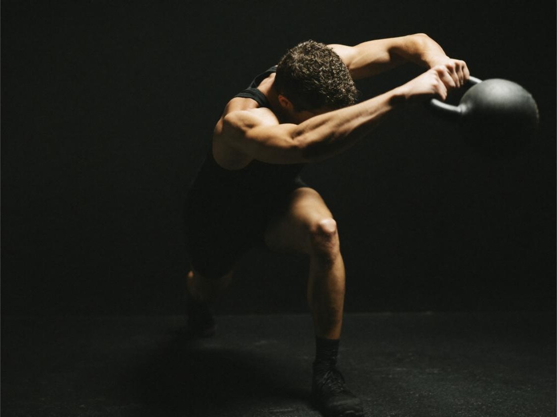 Athlete performing a full-body kettlebell swing